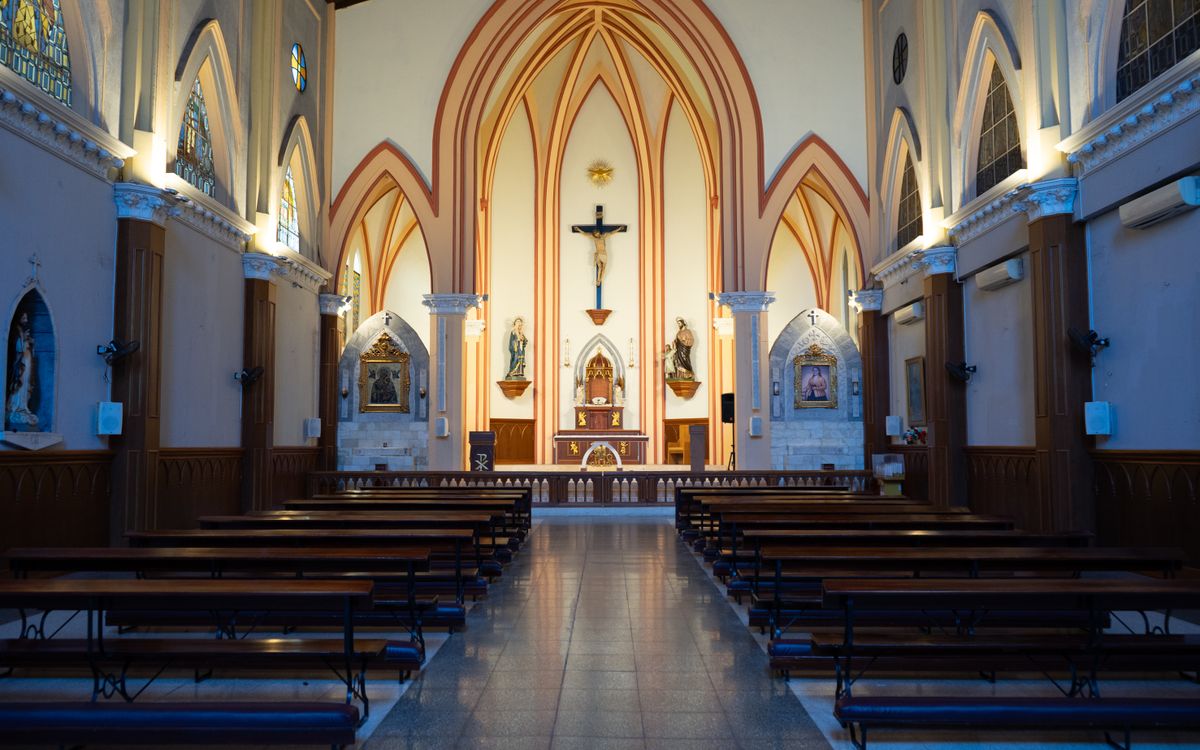 Beautiful Gothic-style church interior in Guayaquil, featuring stained glass windows and intricate architecture.
