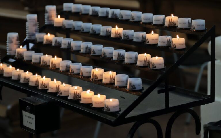 Votive candles lit in Fulda Cathedral, creating a serene religious atmosphere.