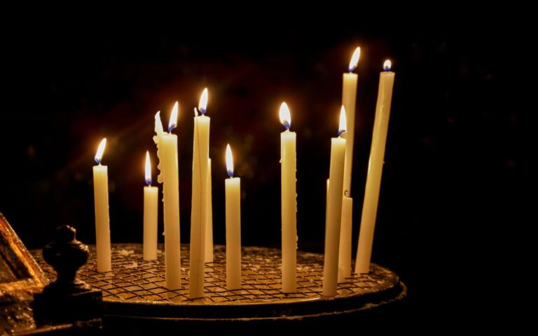 A peaceful scene of votive candles burning in a dimly lit church, symbolizing hope.