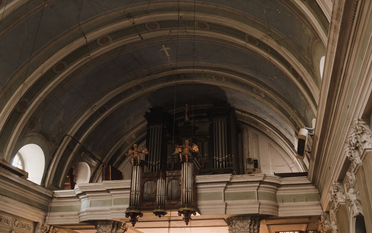 Intricate architectural details in a historic church, featuring ornate organ pipes.