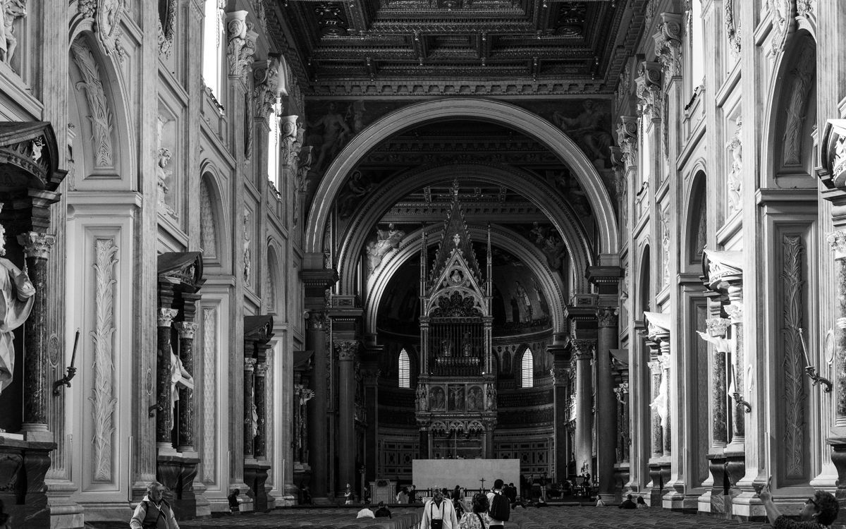 Stunning black and white capture of a grand Roman church interior with intricate decor.