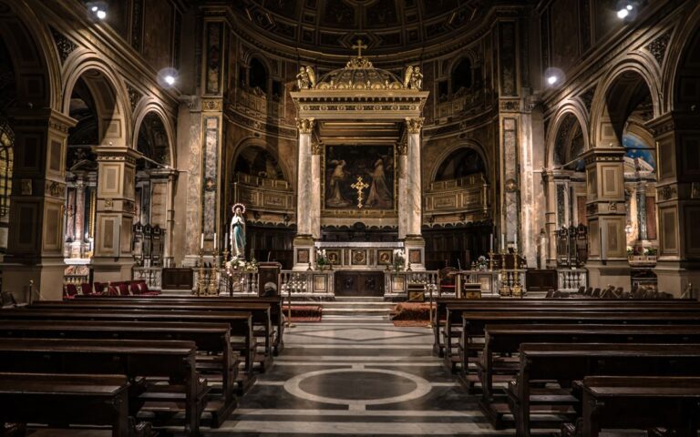 Interior view of a Gothic-style basilica in Rome, showcasing intricate architecture and religious art.