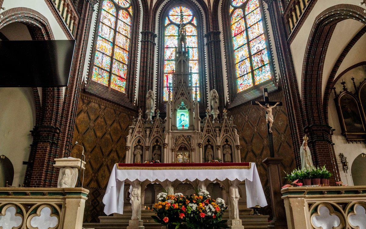 Beautiful gothic church altar adorned with stained glass and intricate designs.