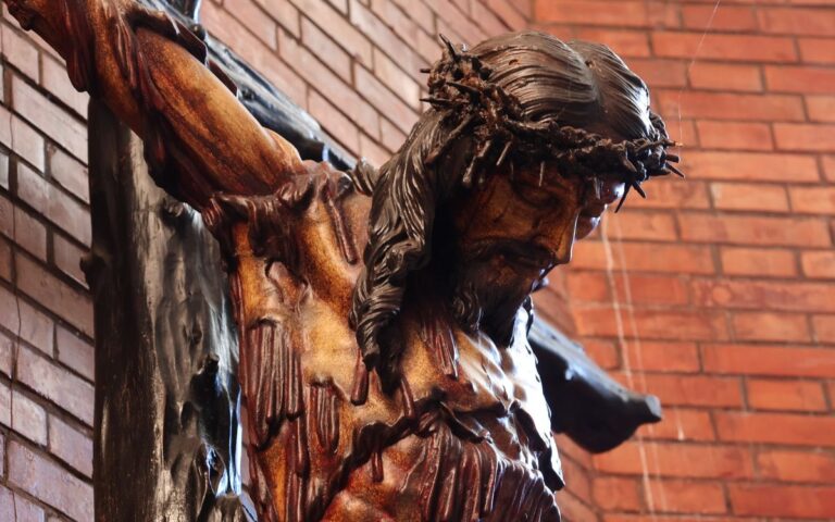 Intricate detail of a crucifix in El Puerto de Santa María, capturing religious devotion.