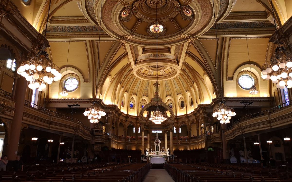 A stunning view of the ornate dome and interior of a Montreal cathedral, highlighting its architectural splendor.