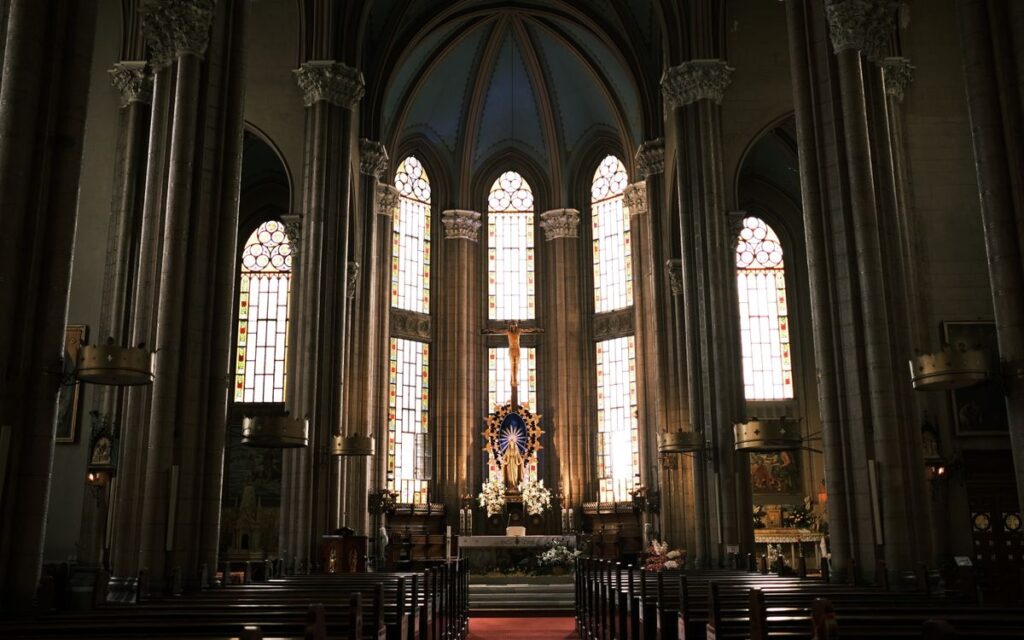 Inside view of St. Anthony of Padua Church showcasing its architecture, stained glass, and altar.